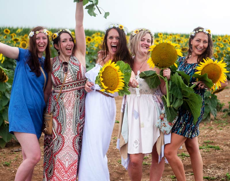 Women enjoying sunflowers